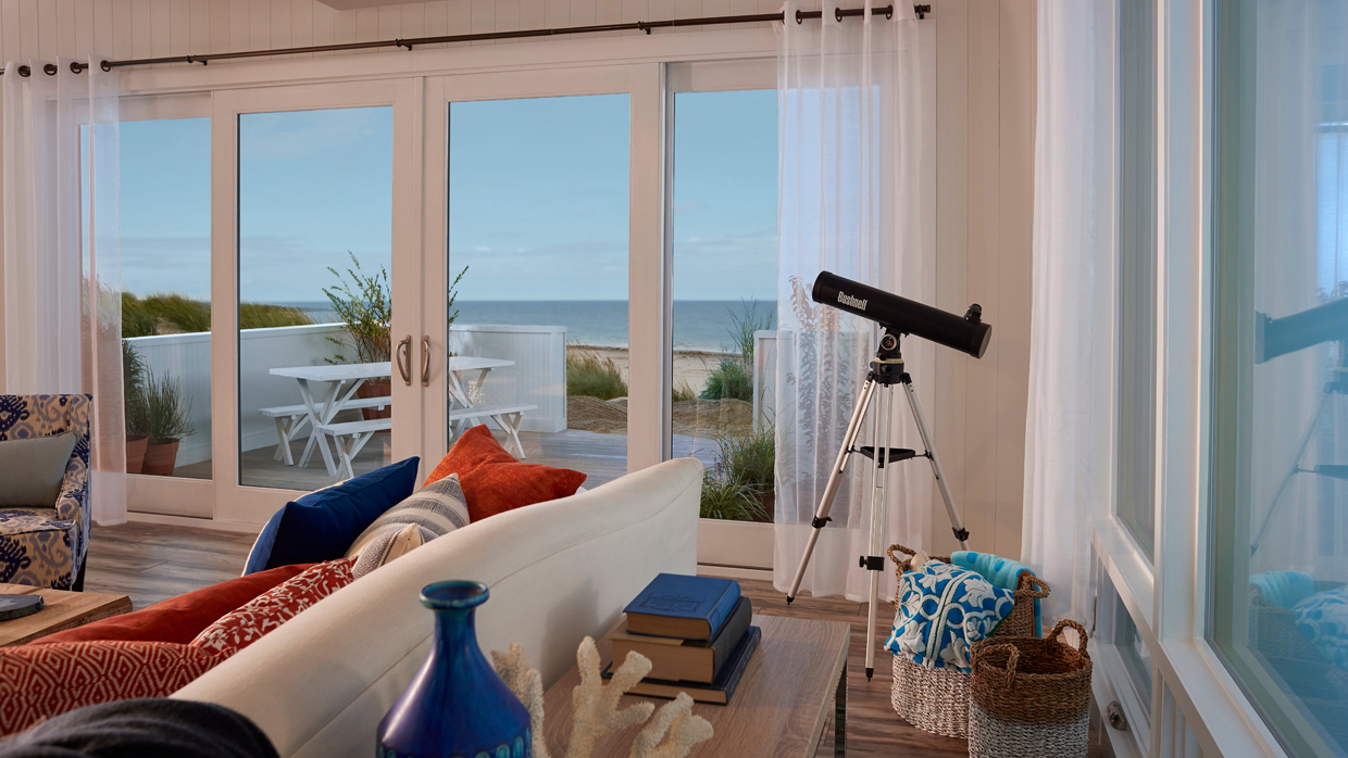 Coastal living room with a bi-parting MIRA sliding patio door overlooking the ocean.